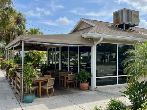 Restaurant with a covered patio and a rooftop AC unit