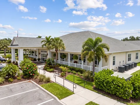 Single-story senior living building with a front porch and AC condensers at one end