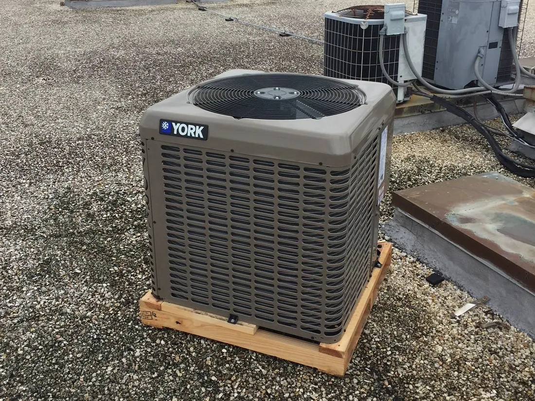 York outdoor unit still on its wooden pallet on a gravel roof