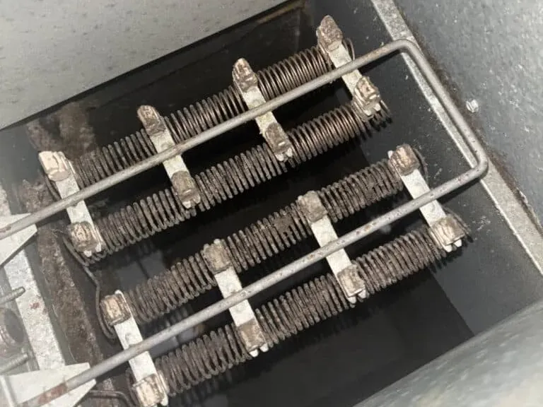 Dusty electric heat strips inside an air handler